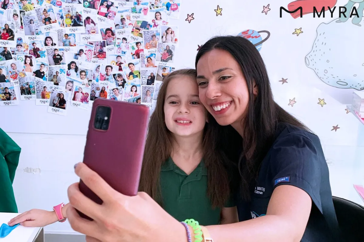 Diş hekimiyle selfie çeken mutlu çocuk hasta